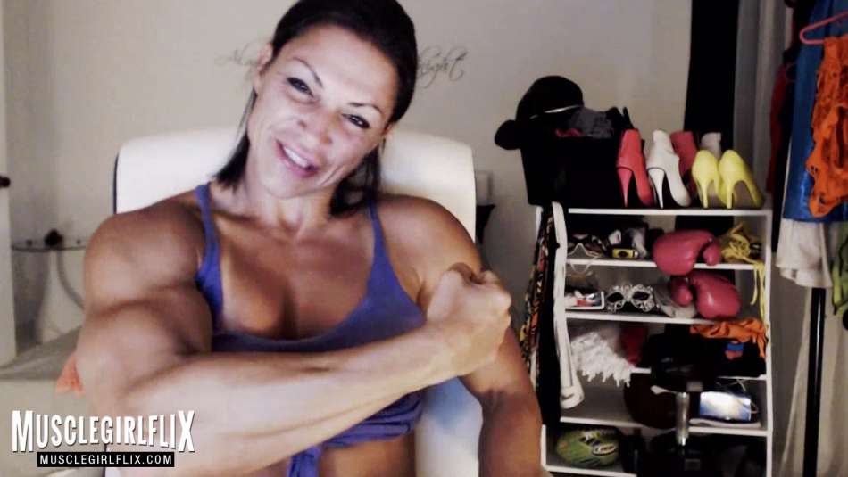 female bodybuilder flexing bicep on her webcam