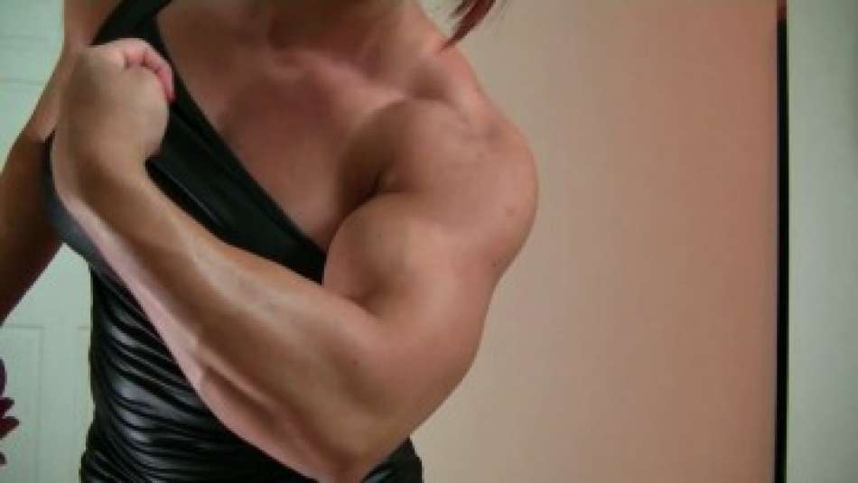 Mz Devious flexes huge bicep muscle